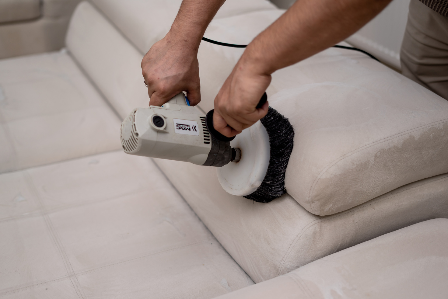 Cleaning a  sofa with a sofa washer