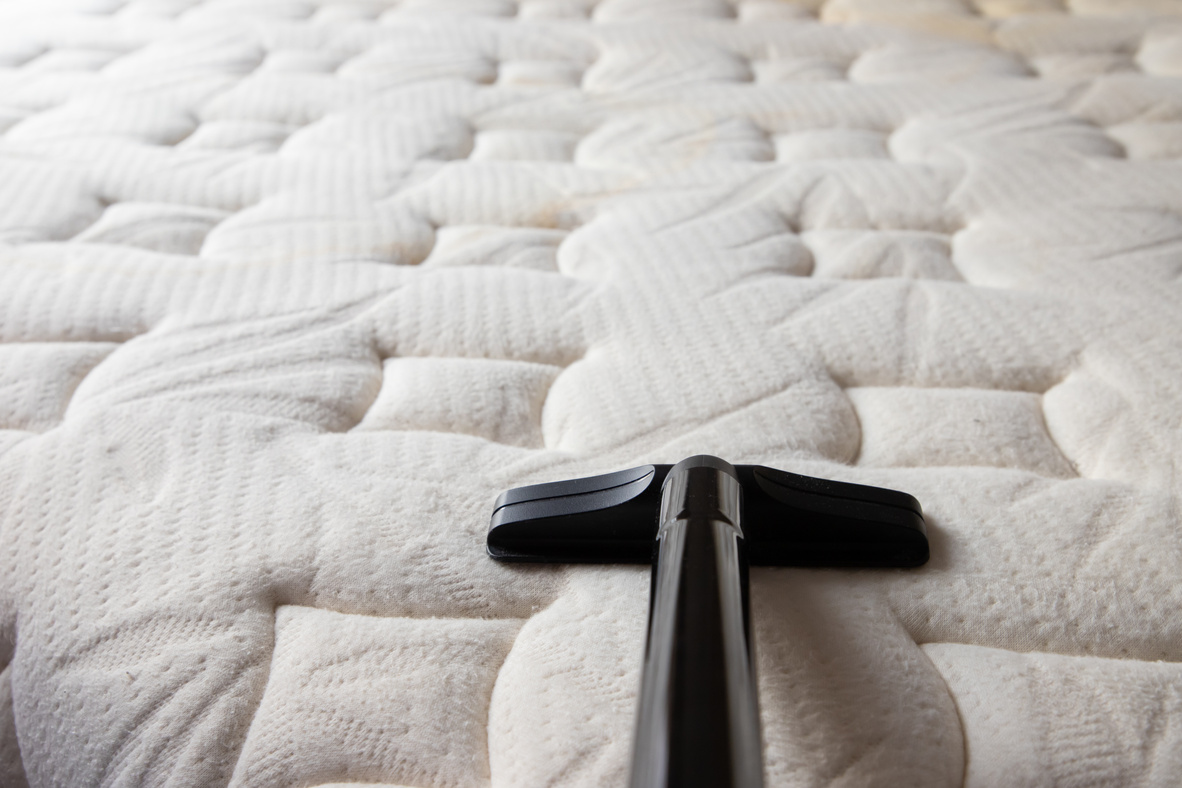 cleaning dirty mattress by vacuum cleaner. dust mites on bed, texture. concept : allergy in bed room.